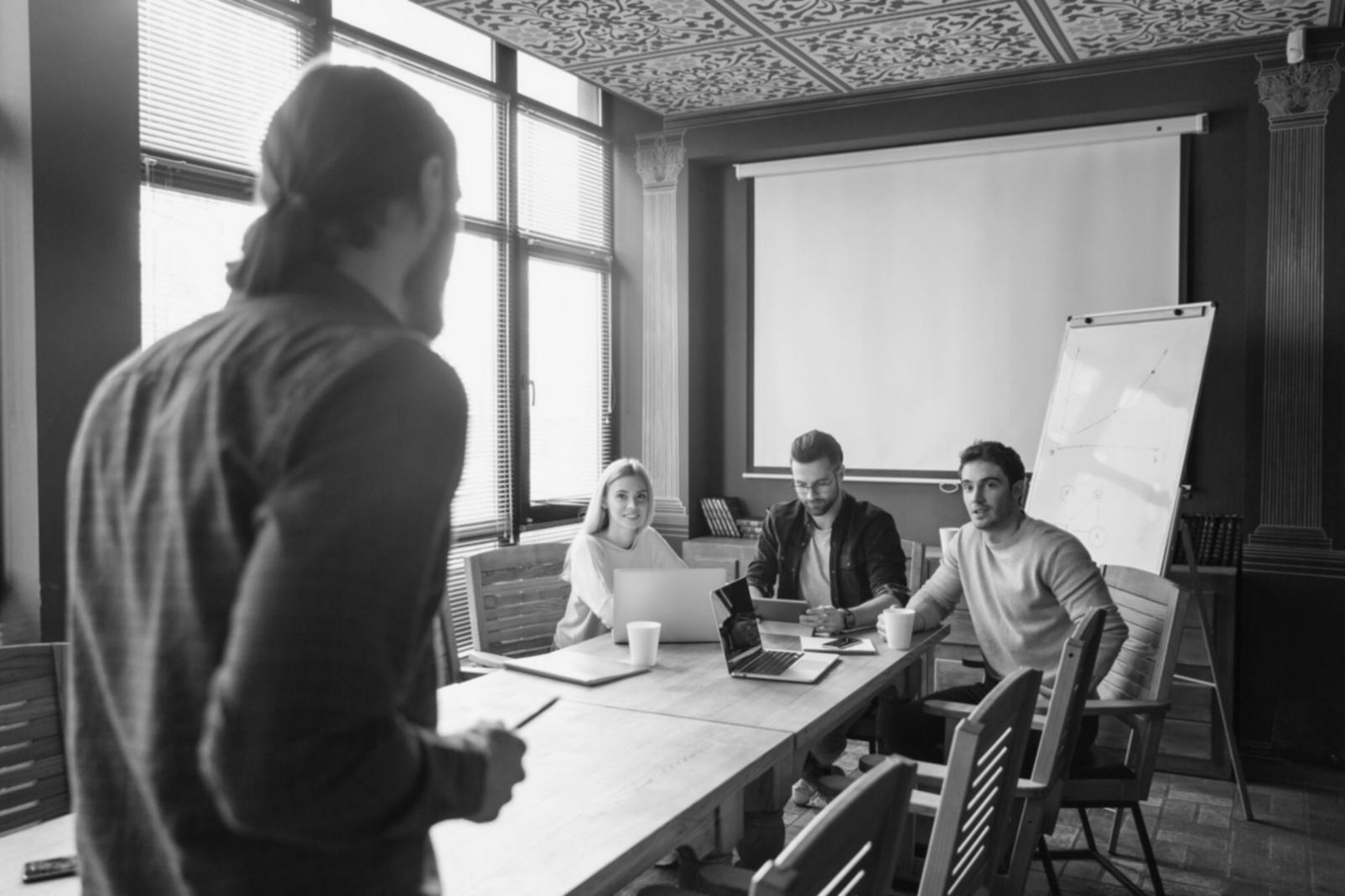 Group of professionals collaborating on financial strategy documents